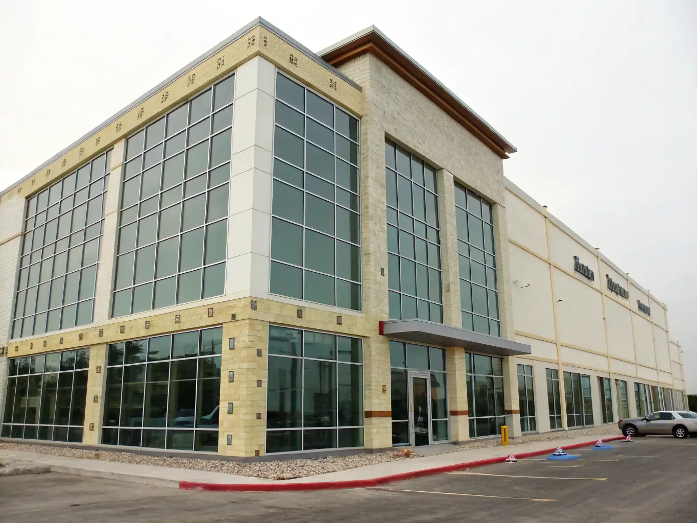 A commercial building renovation project in progress, highlighting KB Master's ability to modernize and enhance existing structures. The image shows workers installing new facade elements and energy-efficient windows.